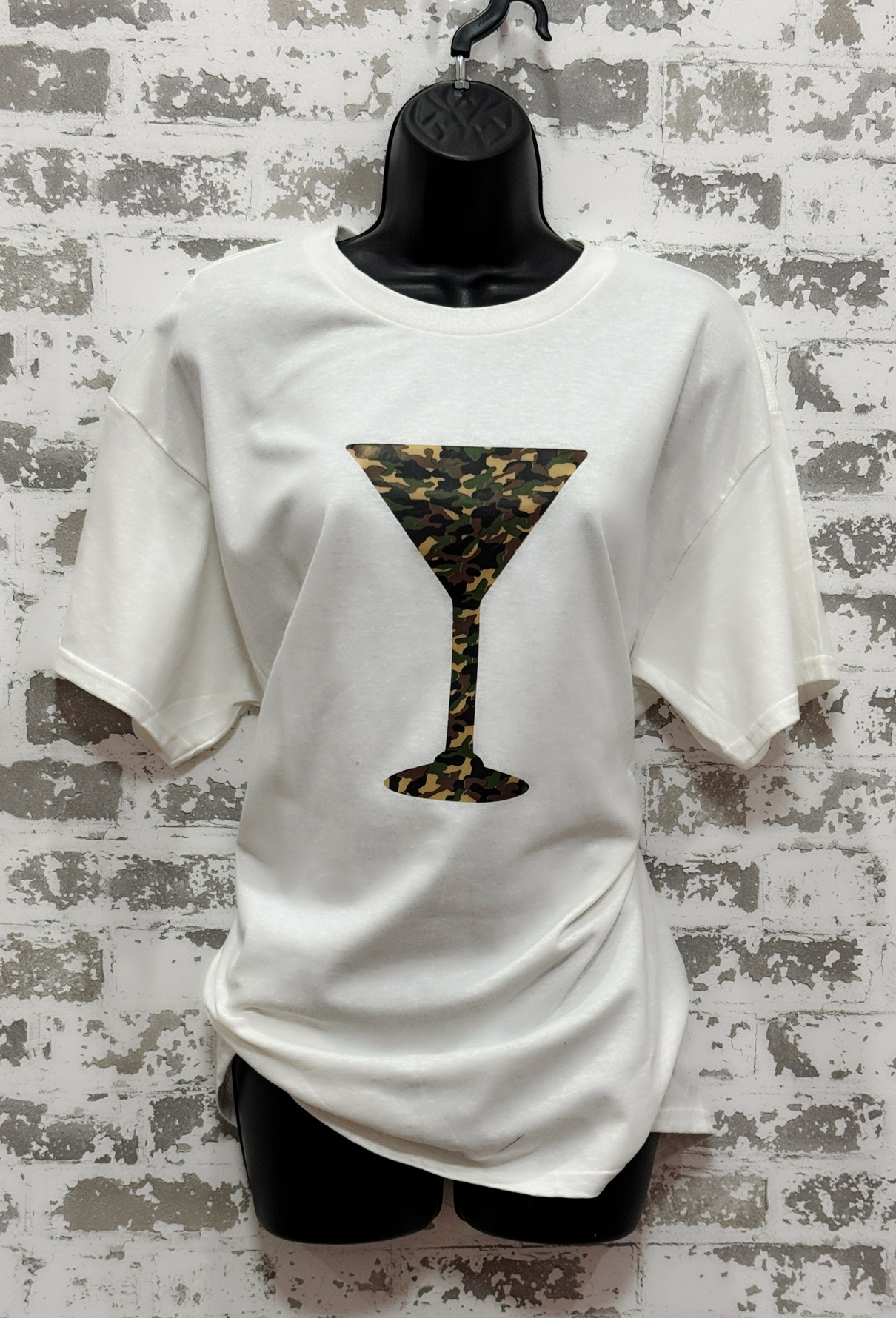 White t-shirt with a camo print martini glass design on a textured gray background