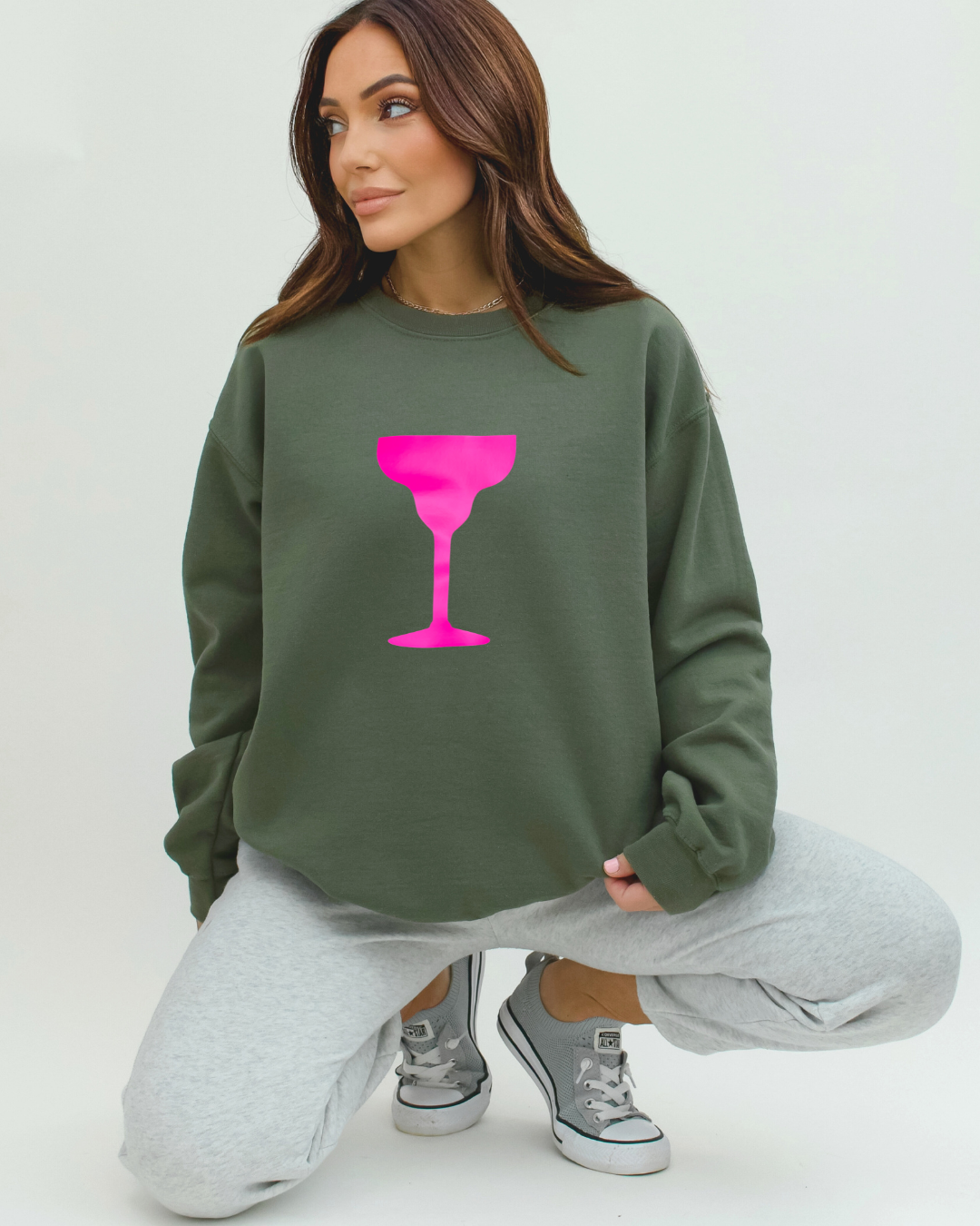 Camo Green Sweatshirt โ Neon Pink Cocktail Glass Graphic from Camo Cocktails Collection on model