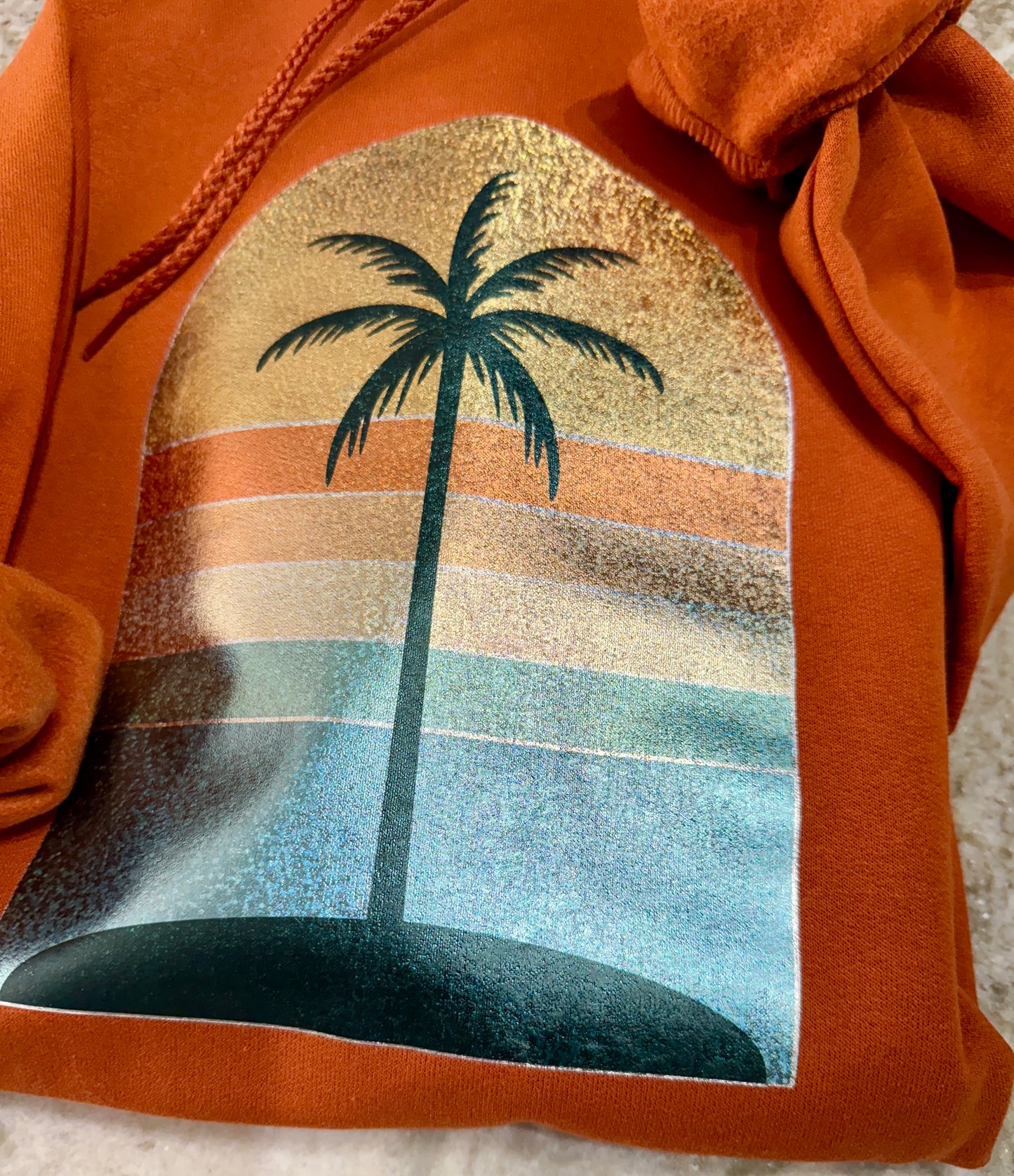 Golden Hour Hoodie – Burnt Orange with Holographic Sunset & Palm Tree Graphic