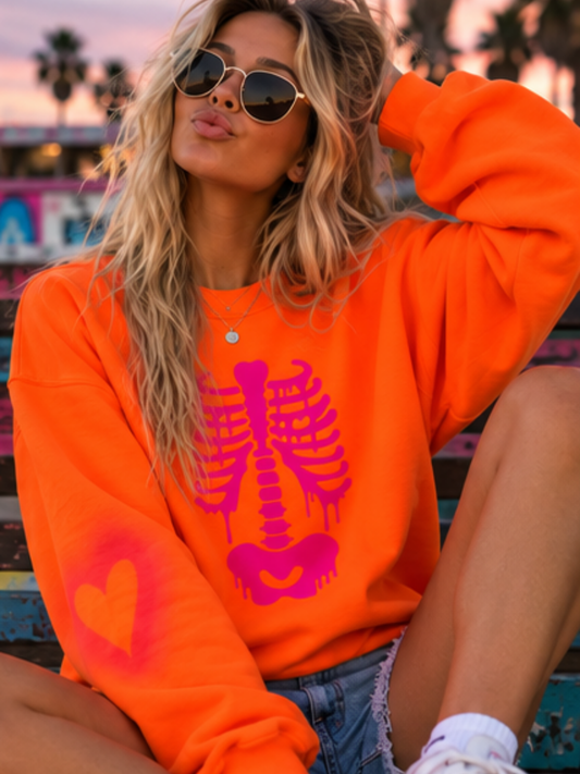 Hand-painted neon orange crewneck sweatshirt featuring a vibrant hot pink dripping skeleton ribcage graphic adorned with scattered, asymmetrical hand-painted hearts.