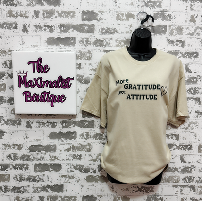 More Gratitude Less Attitude T-Shirt – Sand-Colored Tee with Green Positive Vibes Graphic