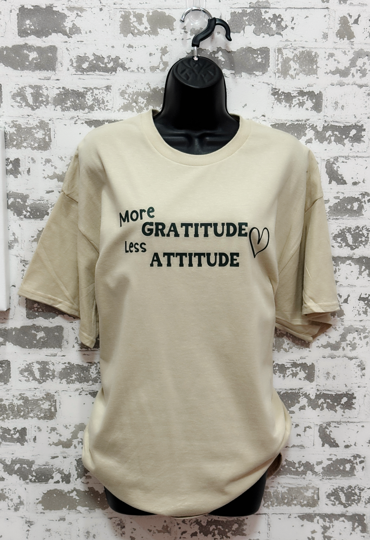 More Gratitude Less Attitude T-Shirt – Sand-Colored Tee with Green Positive Vibes Graphic