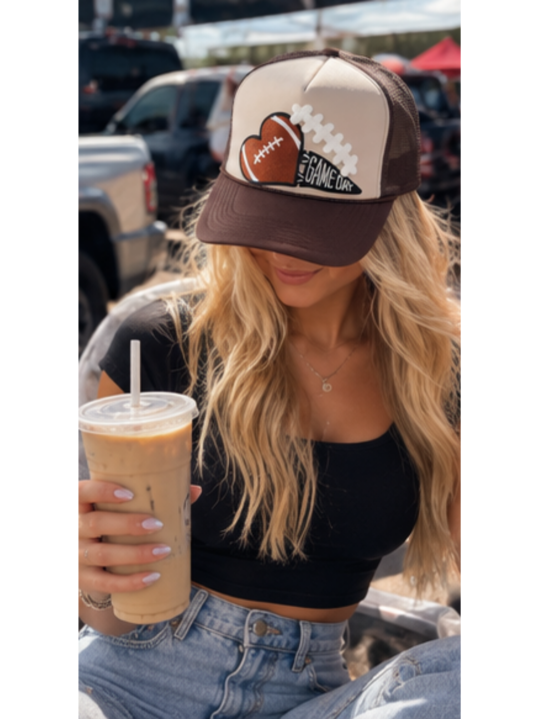 Cream and chocolate brown high-crown trucker hat featuring an embroidered football-heart patch and a GAME DAY pennant emblem, styled with dimensional lace details.