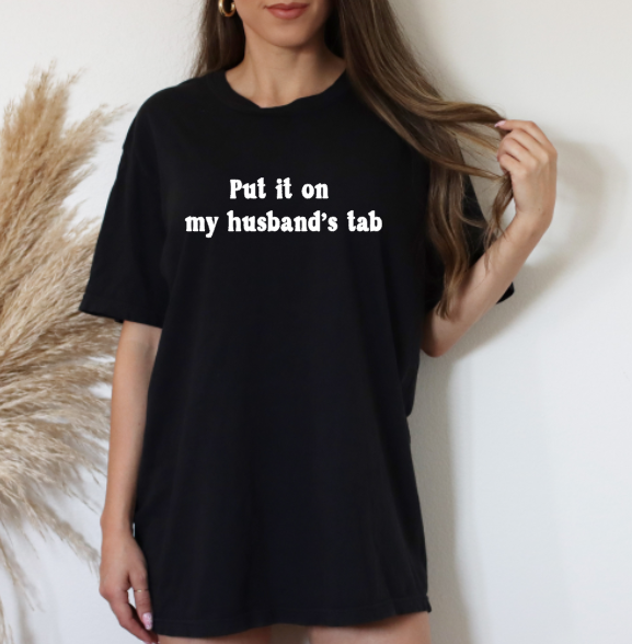 Cheers in Style | Black T-Shirt with "Put It on My Husband's Tab" Graphic
