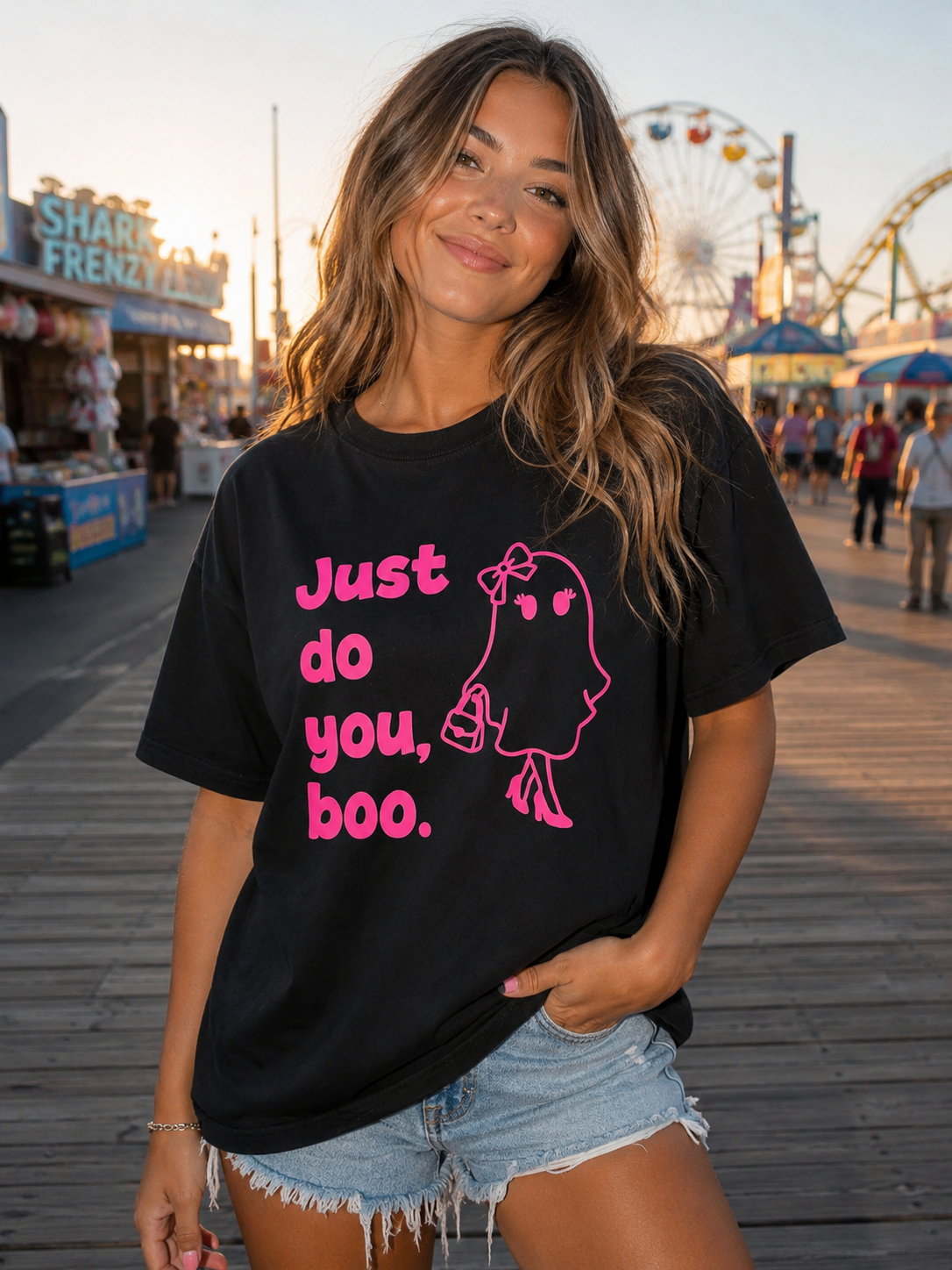 Model wearing a black tee shirt with "just do you, boo" and a girl ghost in pink. 