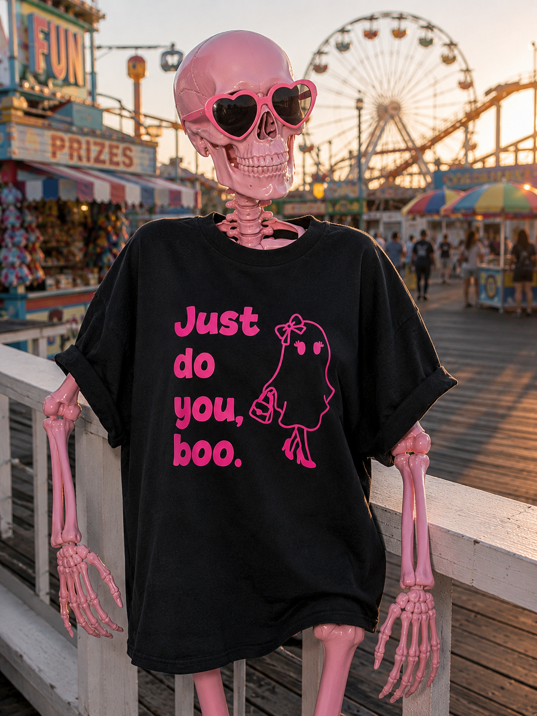 A pink skeleton wearing a black tee shirt with "just do you, boo" and a girl ghost in pink. 