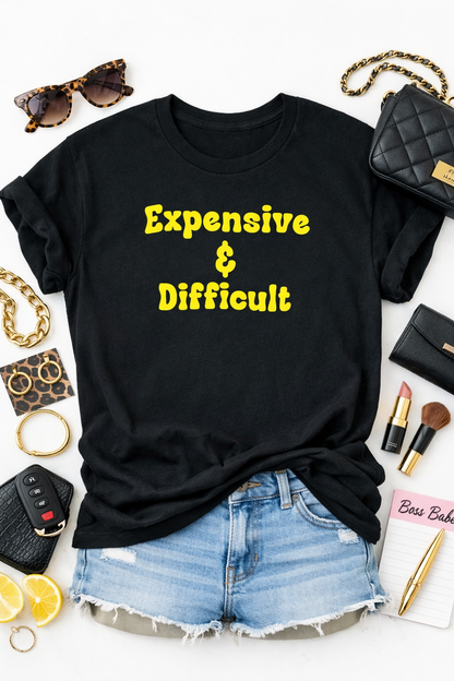 Black t-shirt with 'Expensive & Difficult' text, surrounded by accessories on a white background