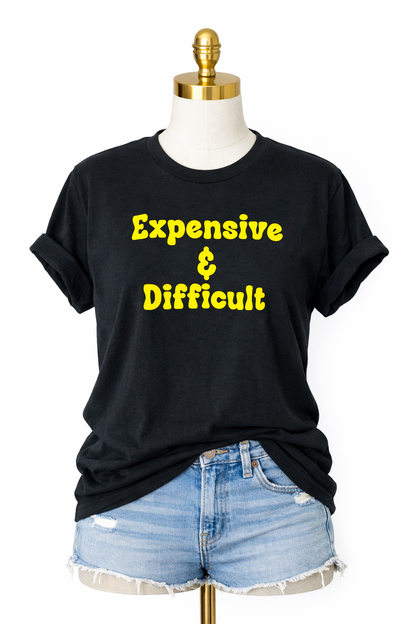 Black t-shirt with yellow text 'Expensive & Difficult' on a mannequin with denim shorts.