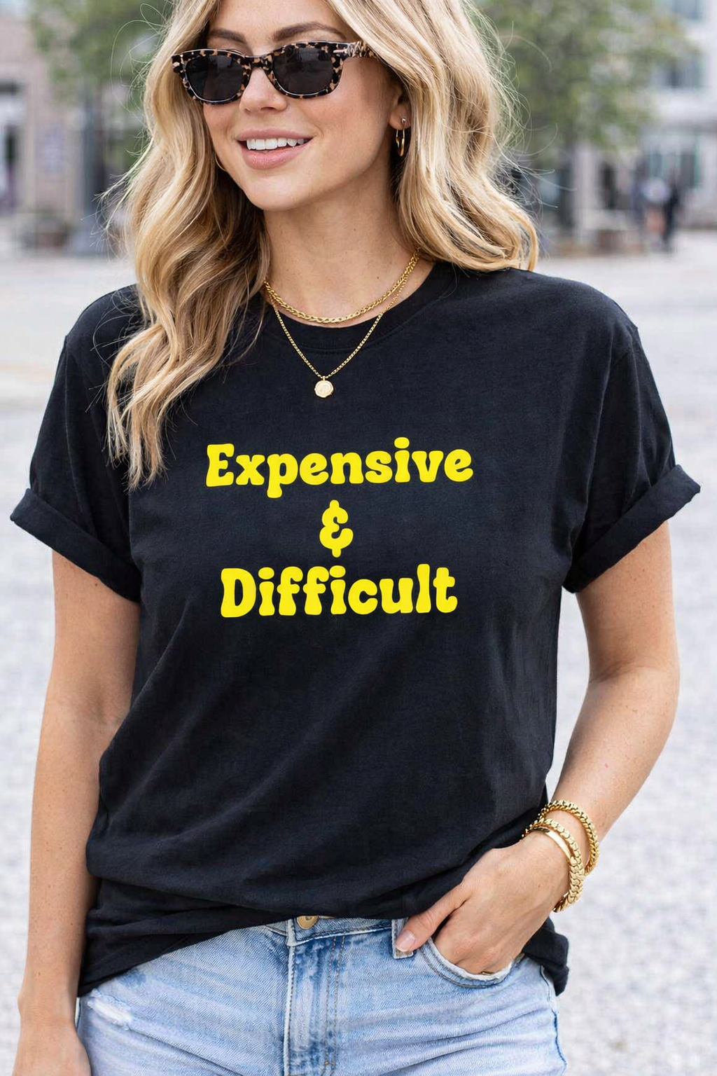 Woman wearing a black t-shirt with 'Expensive & Difficult' text in yellow.