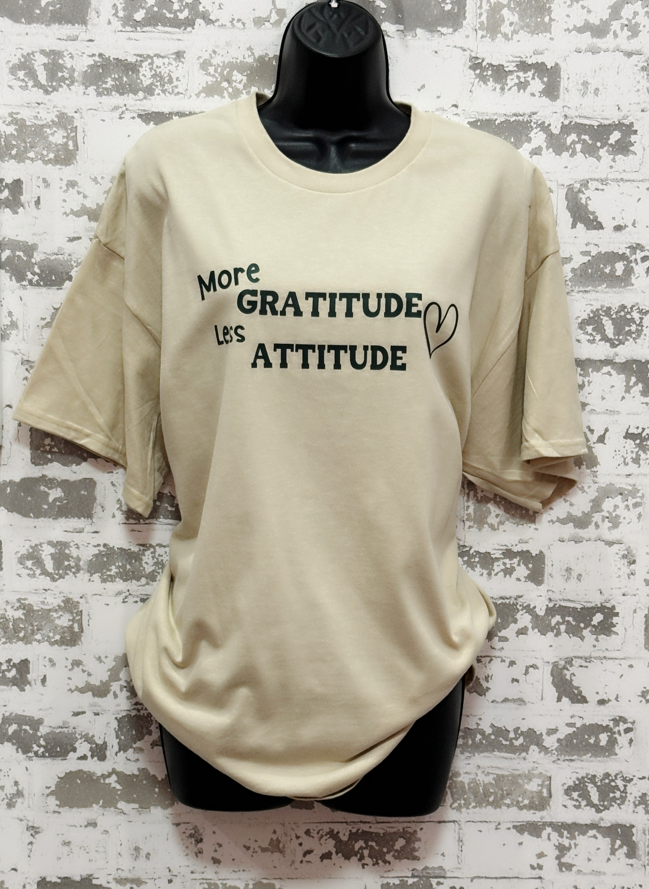 More Gratitude Less Attitude T-Shirt – Sand-Colored Tee with Green Positive Vibes Graphic