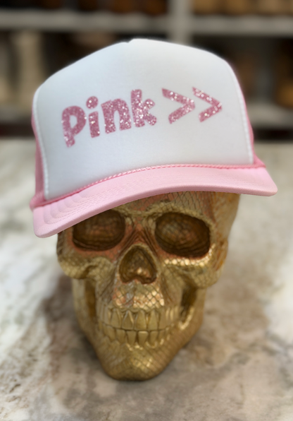 White cap with pink text on a gold skull