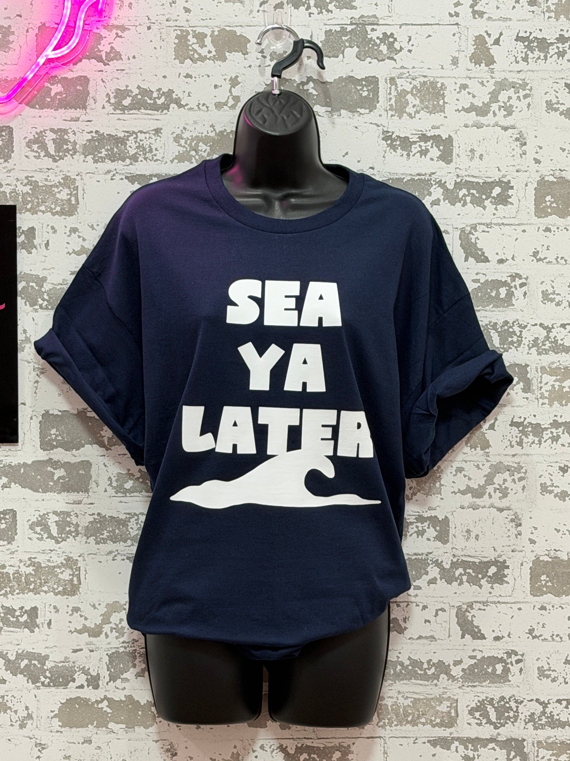 Navy blue hoodie with 'SEA YA LATER' text on a textured surface