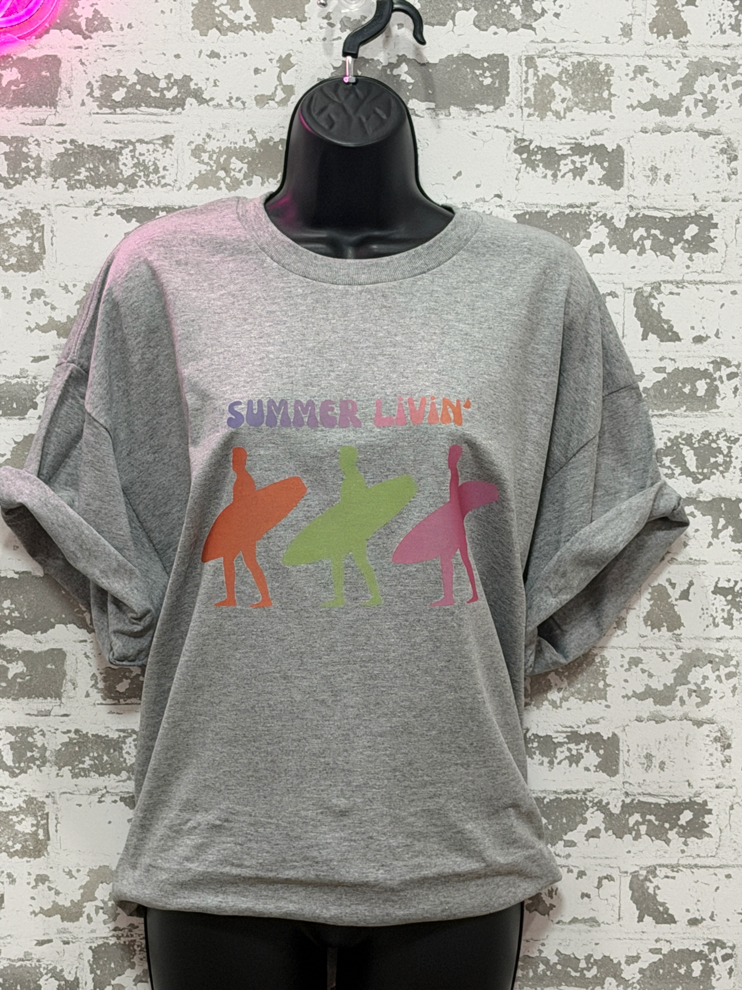Gray t-shirt with colorful graphic and 'Summer LIvin'' text on a textured white background