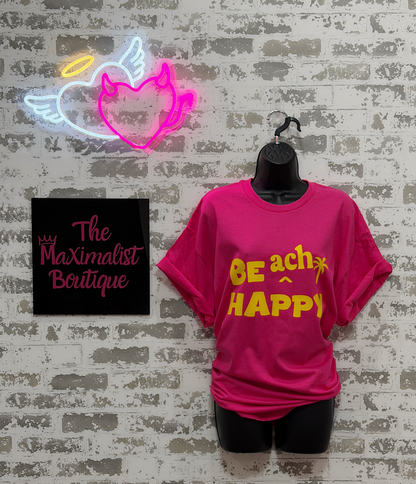 a hot pink shirt with bright yellow "BE ach HAPPY" graphic