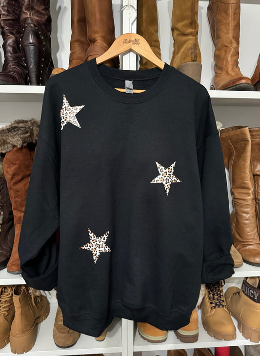 Black sweatshirt with leopard print stars on. front and back