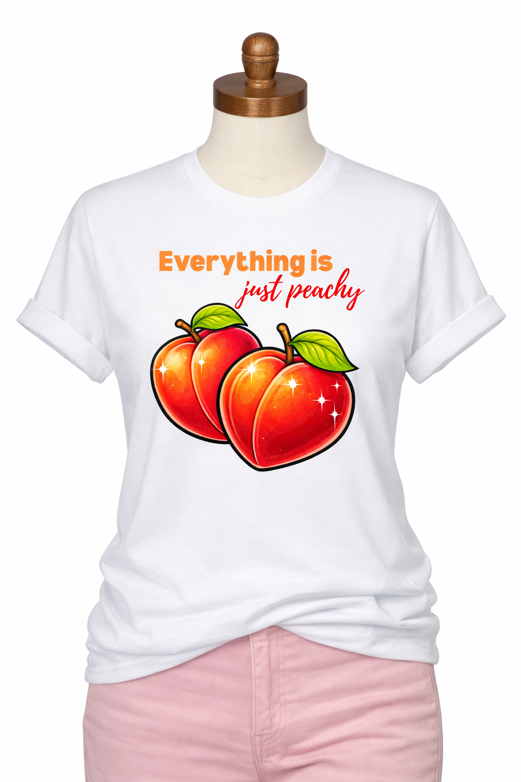 White t-shirt with peaches and text on a mannequin against a white background