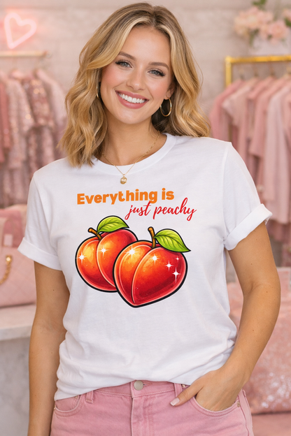Woman wearing a white t-shirt with peach graphics and text in a store setting