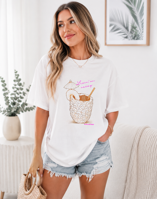 Woman wearing a white t-shirt with a graphic design in a bright room.