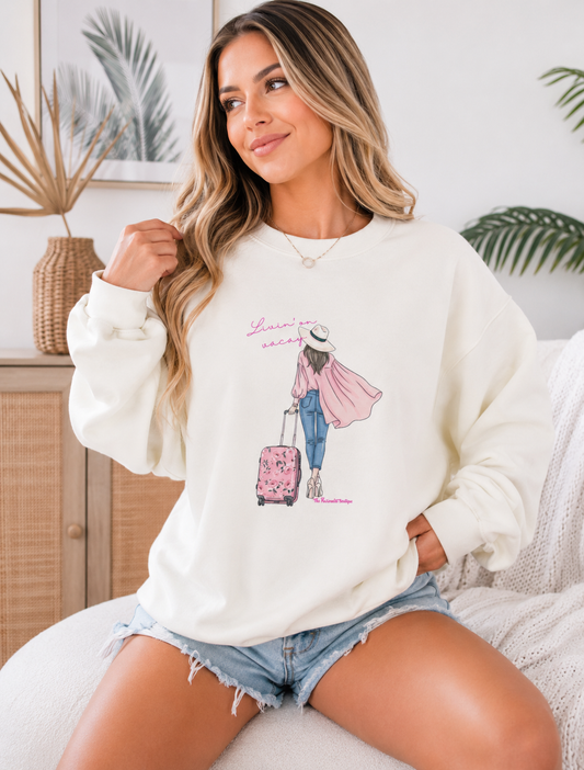 Woman wearing a white sweatshirt with a graphic design sitting on a couch.