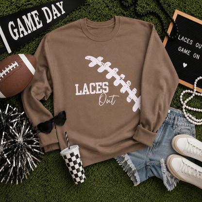  brown sweatshirt with light pink "Laces Out" football graphic 
