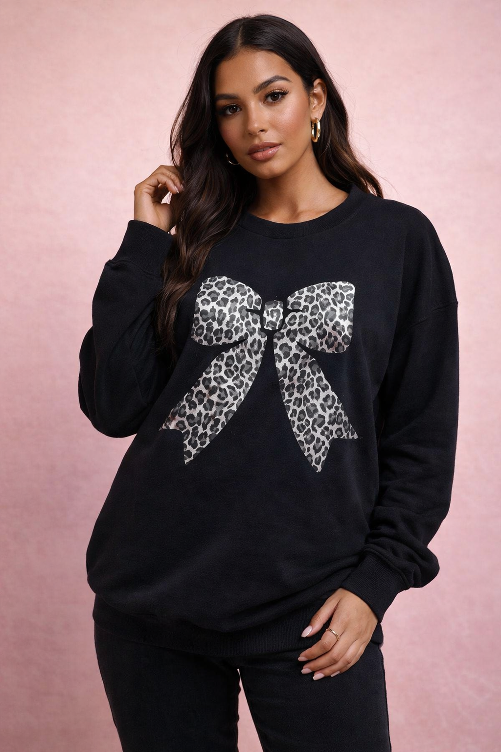 Black sweatshirt with a leopard print bow on a pink background