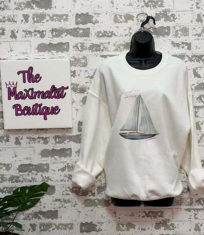 White sweatshirt featuring a sailboat illustration with the phrase “Livin’ On Vacay” across the chest