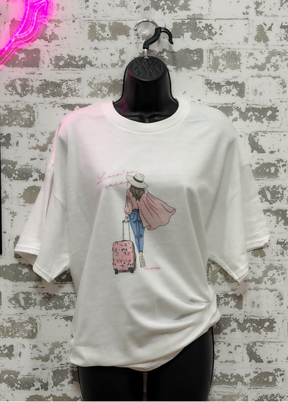 White t-shirt with a graphic design of a person with a suitcase on a hanger against a textured wall.