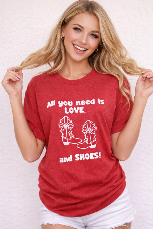Woman wearing a red t-shirt with text and graphics, standing against a plain background