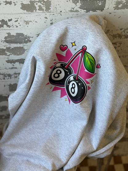 Gray hoodie with a colorful design featuring cherries and number 8 on a distressed wooden surface.