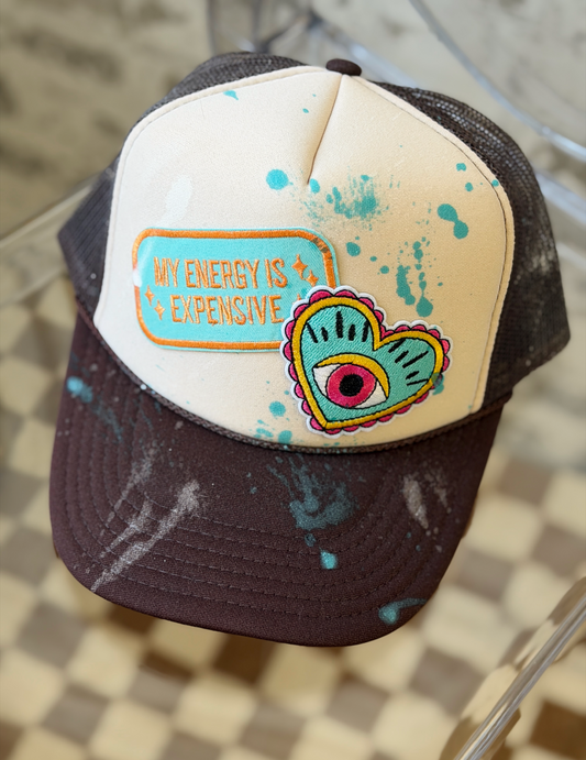 Cap with colorful design and text on a reflective surface