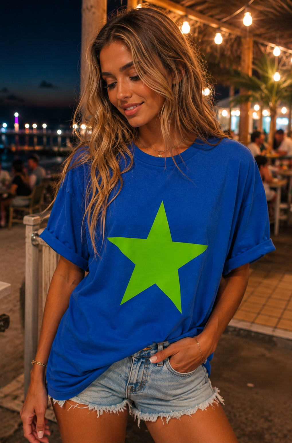 Woman wearing a blue t-shirt with a green star in an outdoor setting