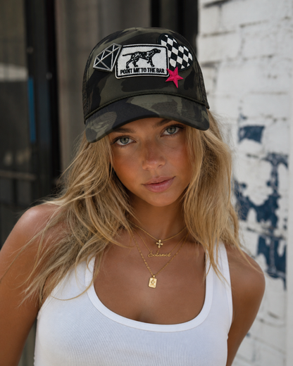 Model wearing camo hat with patches