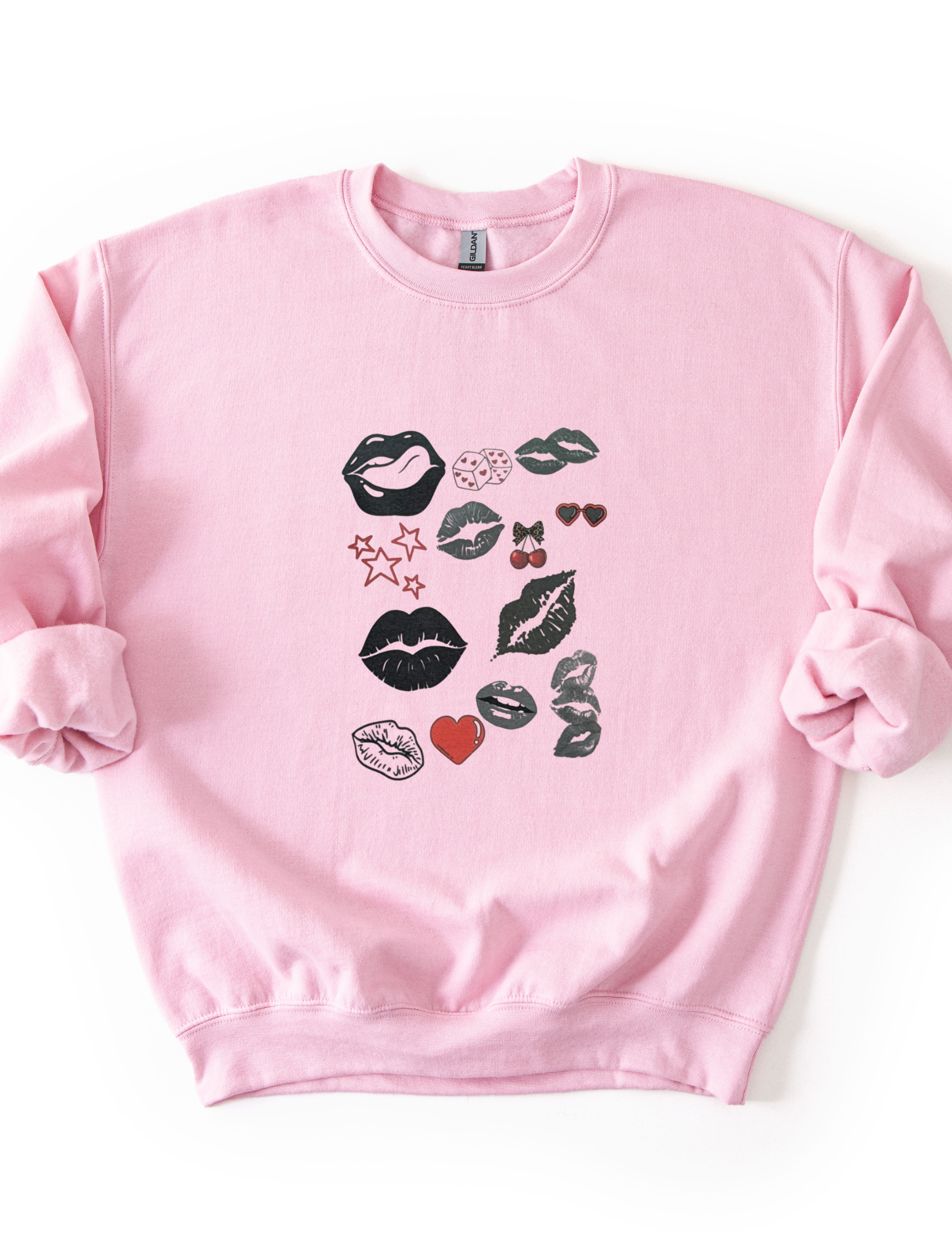 a pink sweatshirt with a bold pop art lip collage design in black and red, part of the XOXO Collection, styled for an everyday graphic statement outfit.