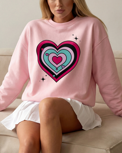 Person wearing a pink sweatshirt with a colorful heart design, sitting on a couch.