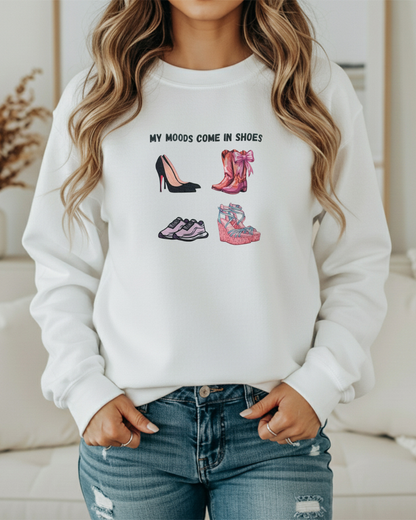Person wearing a white sweatshirt with shoe designs and text