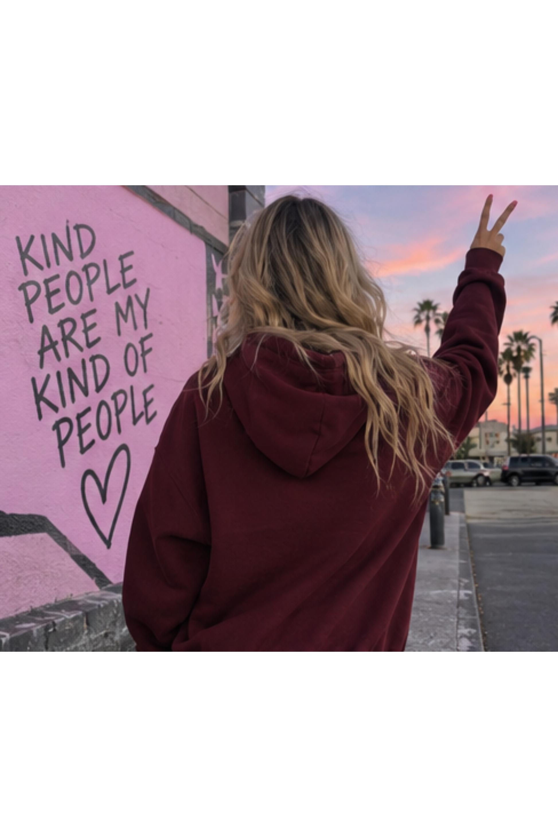 Woman wearing a maroon hoodie that is blank on the back