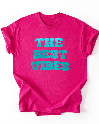 Pink t-shirt with 'THE BEST VIBES' text in turquoise on a white background