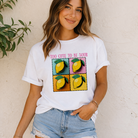 Woman wearing a white t-shirt with lemon graphic and text against a beige wall.