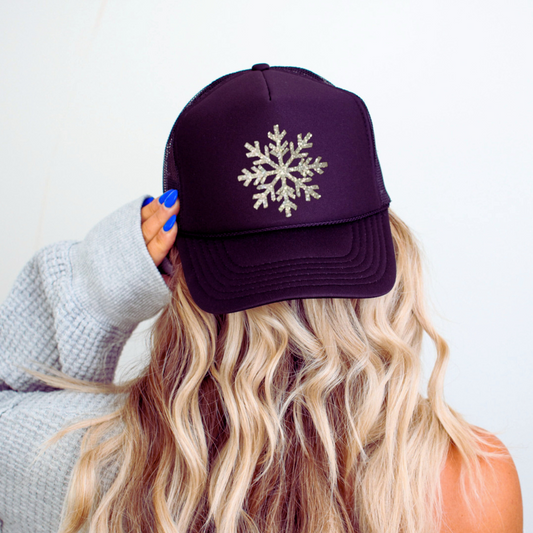 Winter Chic | Black Trucker Hat with Silver Glitter Snowflake Graphic on model