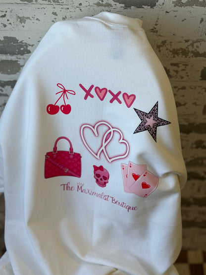 White sweatshirt with colorful graphics and text on a textured surface